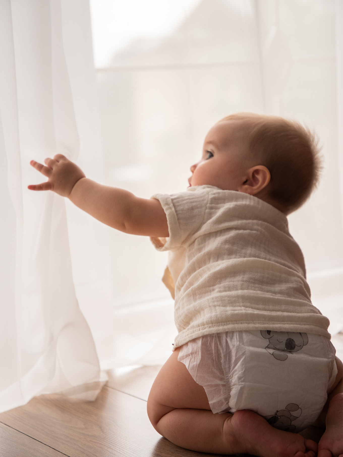 Picture shows an adorable baby crawling in Aiwibi Nappies with Koalas!